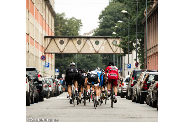 Cars lining the route on the left and right.  Totally Italian.